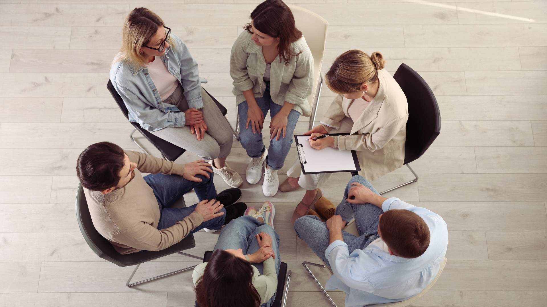 a group of people at addiction counseling
