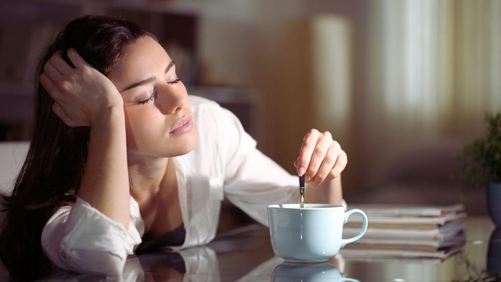 Woman experiencing fatigue, a common effect of depressants or stimulant withdrawal.
