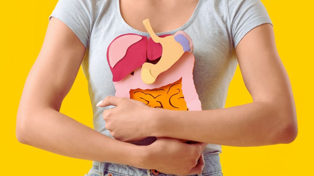 Woman holding paper organs illustrating the physical health effects of long-term heroin use.