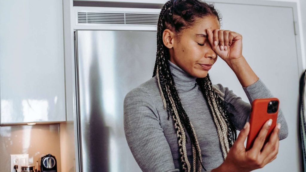 Woman feeling overwhelmed after noticing opioid addiction symptoms in a loved one.