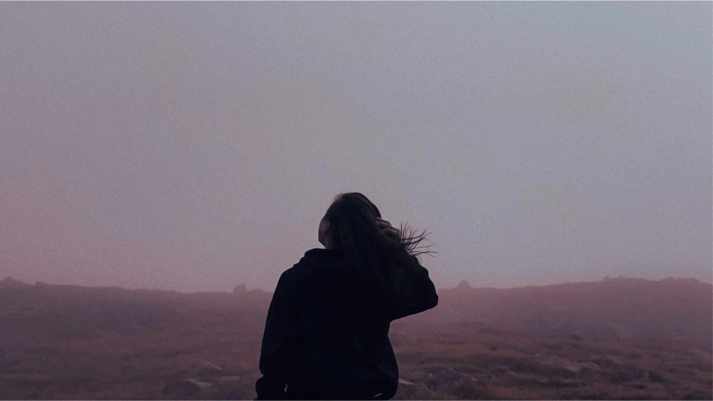 Person standing in fog representing confusion and emotional challenges during Post-Acute Withdrawal Syndrome.