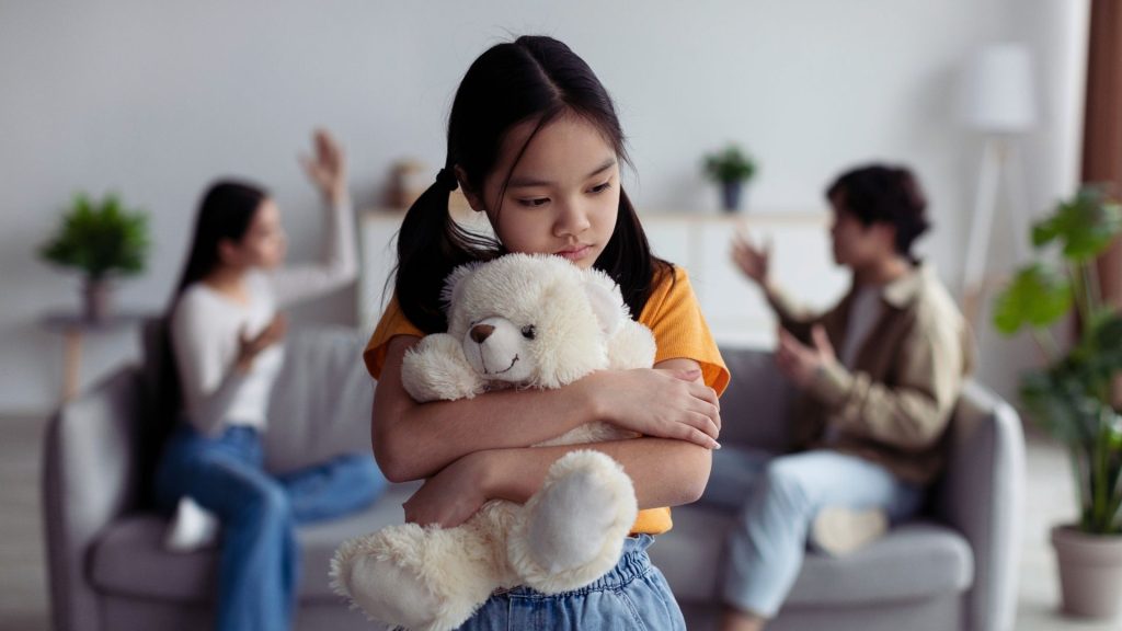 Child upset while parents argue in addiction-affected family
