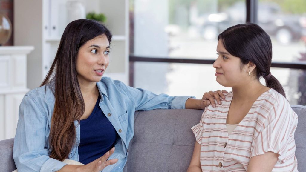 Family members discussing coping strategies during addiction family education session